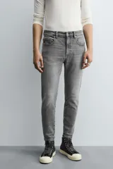 Jeans de hombre, corte skinny y largo cropped, color negro lavado. Presenta cinco bolsillos y cierre frontal con cremallera y botón.