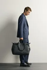 Blazer regular fit azul marino confeccionada en tejido con 20% de lana. Cuenta con cuello con solapas de muesca, manga larga con botones en los puños, bolsillos de vivo en el pecho y de solapa en la cadera, y cierre frontal con botones.