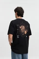 Remera negra de manga corta con cuello redondo y fit regular. Presenta un estampado frontal con gráficos circulares y texto en blanco y naranja.