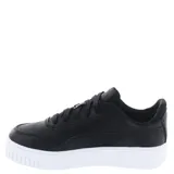 Championes urbanos Puma modelo Carina Street con plataforma, color negro con detalles en dorado. Presentan diseño deportivo con suela de goma blanca y cierre mediante cordones.