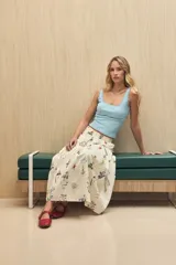 Top sin mangas color celeste claro, con escote cuadrado y detalle de encaje en los bordes del escote y las sisas.