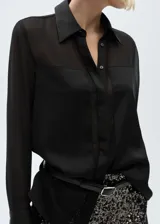 Camisa negra de gasa con tejido fluido, cierre de botones en la parte delantera, diseño recto, cuello camisero y mangas largas abotonadas.
