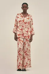 Pantalón ancho de seda viscosa con estampado de flores y tigres en tonos terracota y beige. Cuenta con bolsillos laterales y elástico en la cintura.