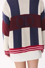 Cardigan de punto con diseño de bloques de color en tonos marrón, beige y verde. Presenta cuello redondo, cierre frontal con botones, mangas largas con hombros caídos y logo bordado en el frente.