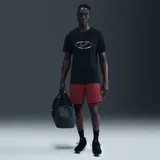 Remera Nike de manga corta, color negro, con diseño gráfico estampado en el pecho que incluye un óvalo abstracto y el logotipo de la marca.