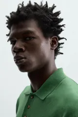 Polo de punto tejido de algodón con efecto lavado, color amarillo pálido. Presenta un calce regular fit, cuello solapa con cierre frontal de tres botones y manga corta.