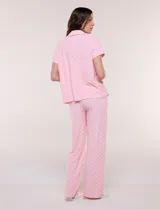 Set de pijama de tres piezas en color verde menta con estampado floral sutil, compuesto por una camisa de manga corta con botones, una musculosa básica y un pantalón largo de corte recto con cordón ajustable en la cintura.