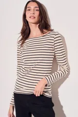 Remera de algodón color crema con rayas horizontales negras, cuello bote y mangas largas.