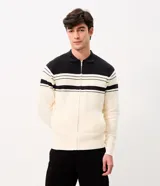 Suéter de punto Marfinno, color blanco y negro con diseño de rayas horizontales bicolor. Cuenta con cuello polo, cierre frontal completo y bolsillos laterales.