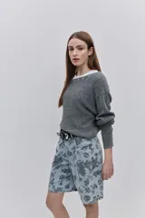 Sweater de punto color tostado, de calce relajado, con escote asimétrico decorado con ojalillos metálicos y mangas largas.
