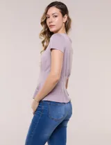 Remera básica de manga corta y cuello redondo, color beige, con detalle de alforzas verticales en el frente que aportan estructura.
