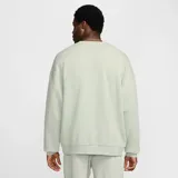 Buzo de cuello redondo Nike Club Fleece, color verde claro, de diseño oversize y mangas largas con hombros caídos. Cuenta con el logotipo Nike Futura bordado en el pecho.
