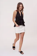Minifalda blanca de denim con tiro medio, diseño de cinco bolsillos y detalles de estrellas metálicas en los laterales.