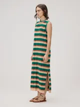 Vestido midi sin mangas de corte holgado, con diseño de rayas horizontales en tonos verde azulado, marrón y rosado. Presenta cuello redondo y aberturas laterales en el dobladillo.