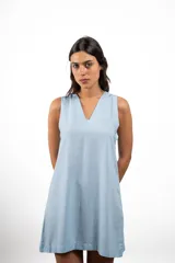 Vestido corto de lino en color beige, con escote en V y diseño sin mangas de corte recto y holgado.