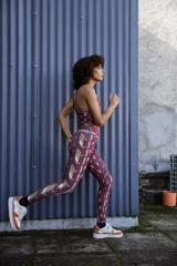 Calza larga de lycra color bordó con estampado de figuras geométricas en tonos rosados.