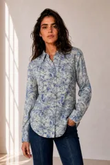 Camisa de manga larga con cuello clásico y cierre frontal de botones, con estampado botánico de hojas en tonos azules y blancos.