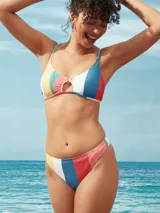 Colaless de lycra estampada con rayas verticales de colores: amarillo, blanco, azul y rojo.