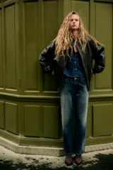 Botín de mujer color marrón oscuro, de serraje con acabado en punta y cierre mediante cremallera. Tiene un tacón estilo cowboy.