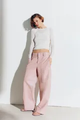 Pantalón de tiro medio de ZARA Woman Collection, confeccionado 100% en piel de color rosado. Cuenta con cintura con trabillas, bolsillos laterales, pespuntes marcados a tono y cierre frontal con cremallera y botón oculto.