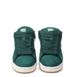 Championes de mujer color beige claro, estilo skate o urbano, con cordones anchos y suela gruesa de goma color caramelo. Presentan paneles superpuestos de gamuza y detalles lisos.