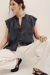 Camisa sin mangas de lyocell con efecto acid wash en color gris oscuro, cuello redondo con escote en V y pliegues en los hombros.
