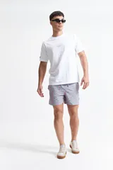 Short de baño estampado con cintura elástica, cordón ajustable, dos bolsillos laterales y uno trasero.