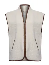 Chaleco de polar tipo corderito en color beige, con cierre frontal y detalles de ribetes en color marrón. Presenta bolsillos laterales y un diseño sin mangas.