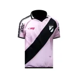 Camiseta de fútbol rosada con una banda diagonal negra que cruza el pecho. En la banda se encuentra el escudo del club y cuatro estrellas doradas.