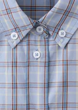 Camisa oversize de algodón con estampado a cuadros, cuello camisero, cierre frontal de botones y mangas largas.