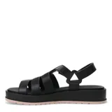 Sandalias de plataforma tipo jaula con tiras anchas de material sintético en color blanco hueso, cierre de velcro en el tobillo y suela de goma negra con base color caramelo.