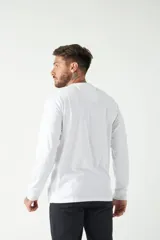 Remera de manga larga con cuello redondo y calce regular. Presenta un pequeño logo bordado en el pecho.