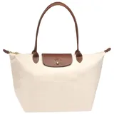 Bolso tipo shopper de cuerpo plegable en color crema o blanco roto, con asas y solapa de cierre en cuero marrón texturizado. Presenta un bolsillo exterior frontal y cierre principal con broche metálico.