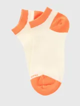 Calcetín corto tipo soquete color crema con detalles en naranja en el puño, talón y puntera. Incluye logo de la marca estampado en la zona de los dedos.