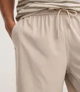 Bermuda masculina color beige, tipo boardshort, confeccionada en microfibra. Cuenta con cintura elástica, cordón ajustable y bolsillos.