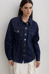 Chaqueta de denim color marrón, con corte entallado en la cintura, cierre frontal con botones metálicos y bolsillos superiores con solapa.
