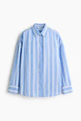 Camisa oversize confeccionada en mezcla de lino y viscosa, con diseño a rayas verticales en tonos celeste y blanco. Cuenta con cuello clásico, cierre frontal de botones, hombros caídos y mangas largas con puños abotonados.