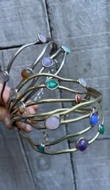 Gargantilla artesanal con cuatro hilos de bronce y alpaca, adornada con piedras de diferentes colores y formas.