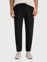 Pantalón de corte recto y estilo casual, confeccionado en tejido técnico elástico. Presenta cintura elástica con cordón de ajuste y bolsillos laterales.