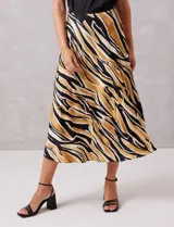 Falda midi de satén con estampado tribal en tonos negro, beige y mostaza. Presenta un corte fluido y cintura elastizada para mayor comodidad.