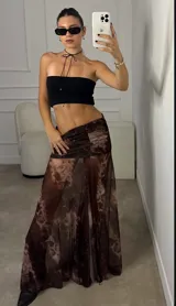 Pollera midi de corte evasé con cintura fruncida y diseño estampado con efecto marmolado en tonos marrones.