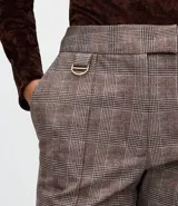 Pantalón de corte flare con estampado de cuadros, confeccionado en tejido punto roma estructurado. Presenta cintura estructurada, ajuste ceñido en caderas y muslos con apertura suave en el ruedo y detalle metálico lateral.