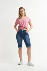 Pantalón capri de denim celeste claro, corte ajustado al cuerpo con tiro alto, bolsillos clásicos y botamangas con vuelta.