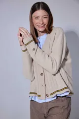Saco tipo cardigan tejido en lana, con diseño de ochos y rombos en el frente. Presenta detalles de doble raya en contraste en los puños y el ruedo, cierre frontal con botones y logo bordado en la manga.