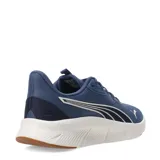 Championes Puma Flexfocus Lite Modern de color azul, con diseño deportivo de malla textil y detalles sintéticos. Presenta el logo de la marca en el lateral y en la puntera, con una entresuela blanca de amortiguación ligera y suela de goma en tono caramelo.