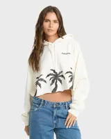 Buzo hoodie Billabong de corte cropped, color blanco, con capucha y cordón ajustable. Cuenta con estampado de palmeras negras en la parte inferior y el logo de la marca bordado en el pecho.