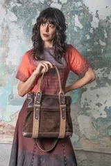 Bolso marrón de cuero graneado y gamuza, con detalles y manijas de cuero con textura croco color habano. Incluye correa desmontable y regulable para usar al hombro o cruzado.