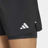 Short deportivo Adidas 2 en 1, compuesto por un short exterior tejido y liviano con un short interior elástico integrado. Cuenta con cintura elástica con cordón de ajuste y bolsillos laterales en la capa interna.