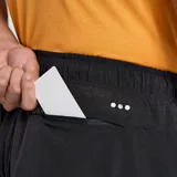 Short de running negro con logo reflectivo de la marca en blanco.