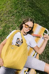 Bolso deportivo tipo duffel bag de nylon color verde oliva, con asas de mano y correa ajustable para llevar al hombro.